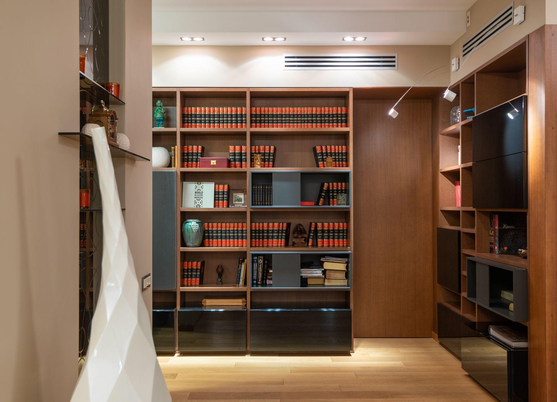 A private study lined with dark-wood shelves and leather-bound volumes