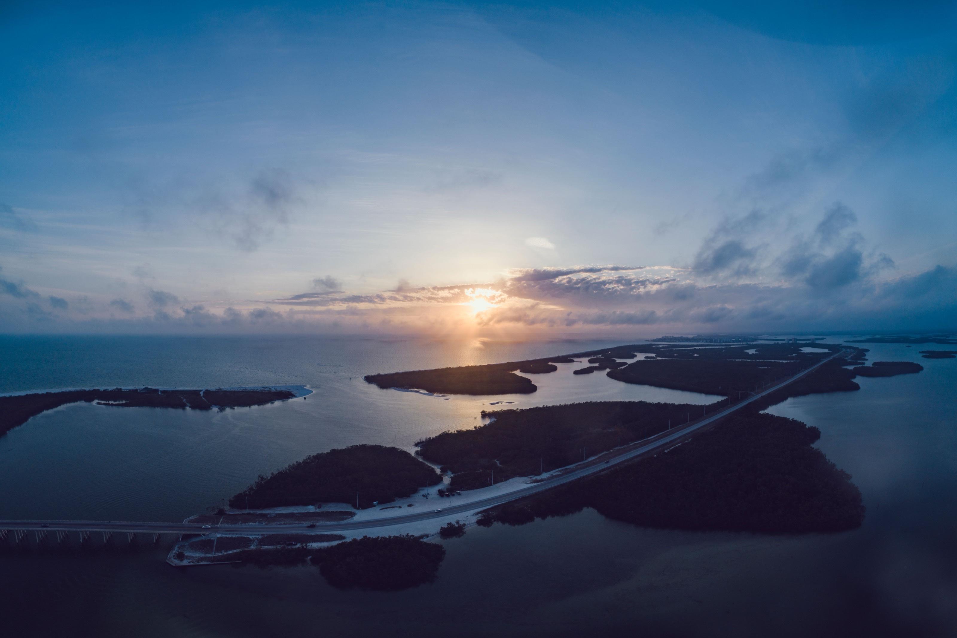 Aerial view of sunset over mangrove islands and calm coastal water near Fort Myers Beach, Florida