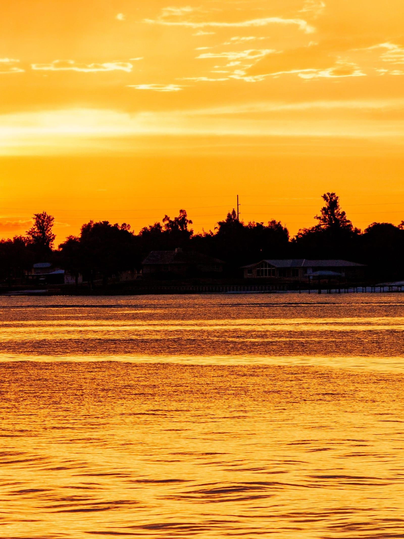 The sun setting over Lake Placid in Highlands County, the water lit orange