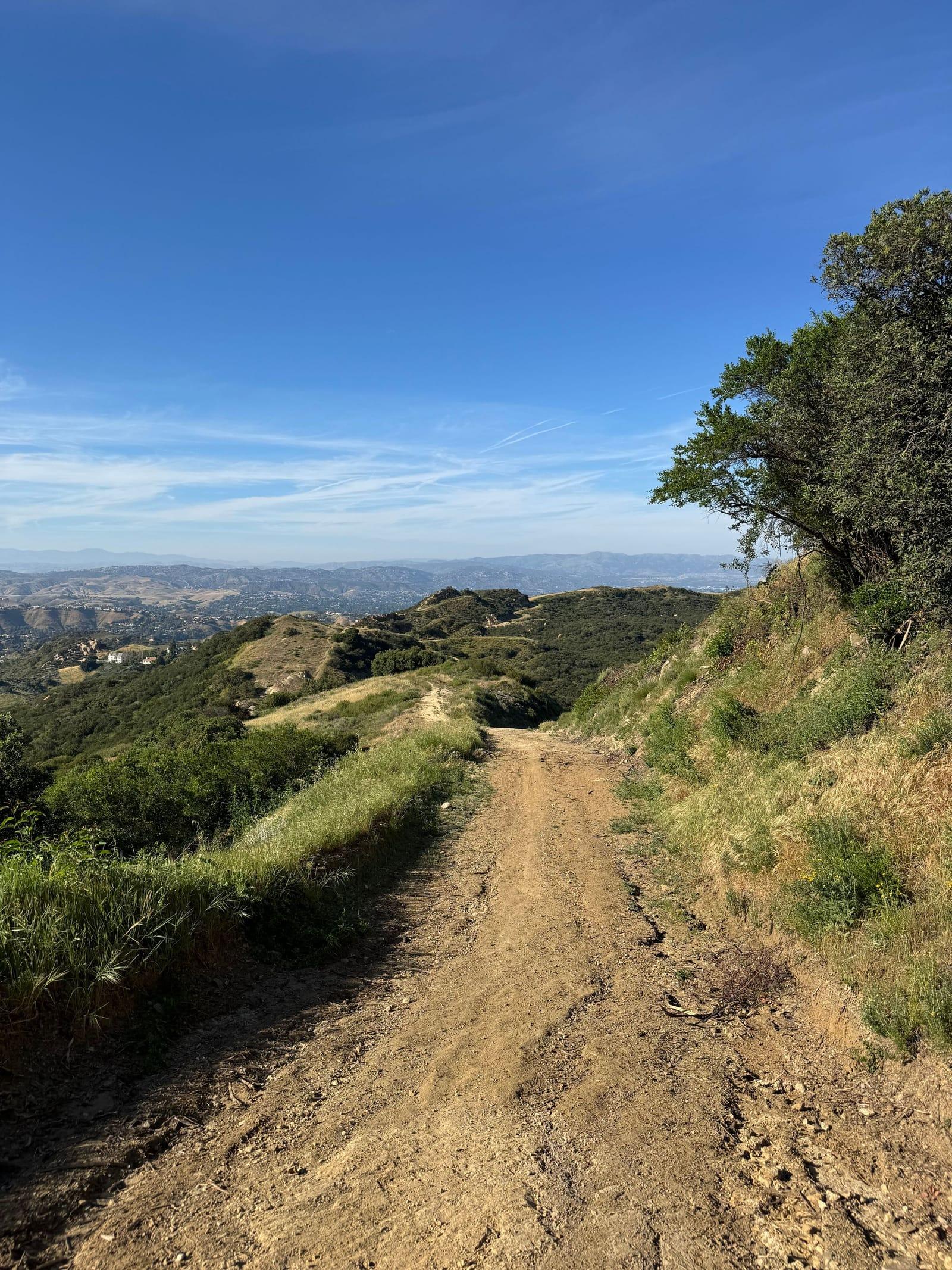 A dirt trail winding through the Santa Monica Mountains on a sunny day
