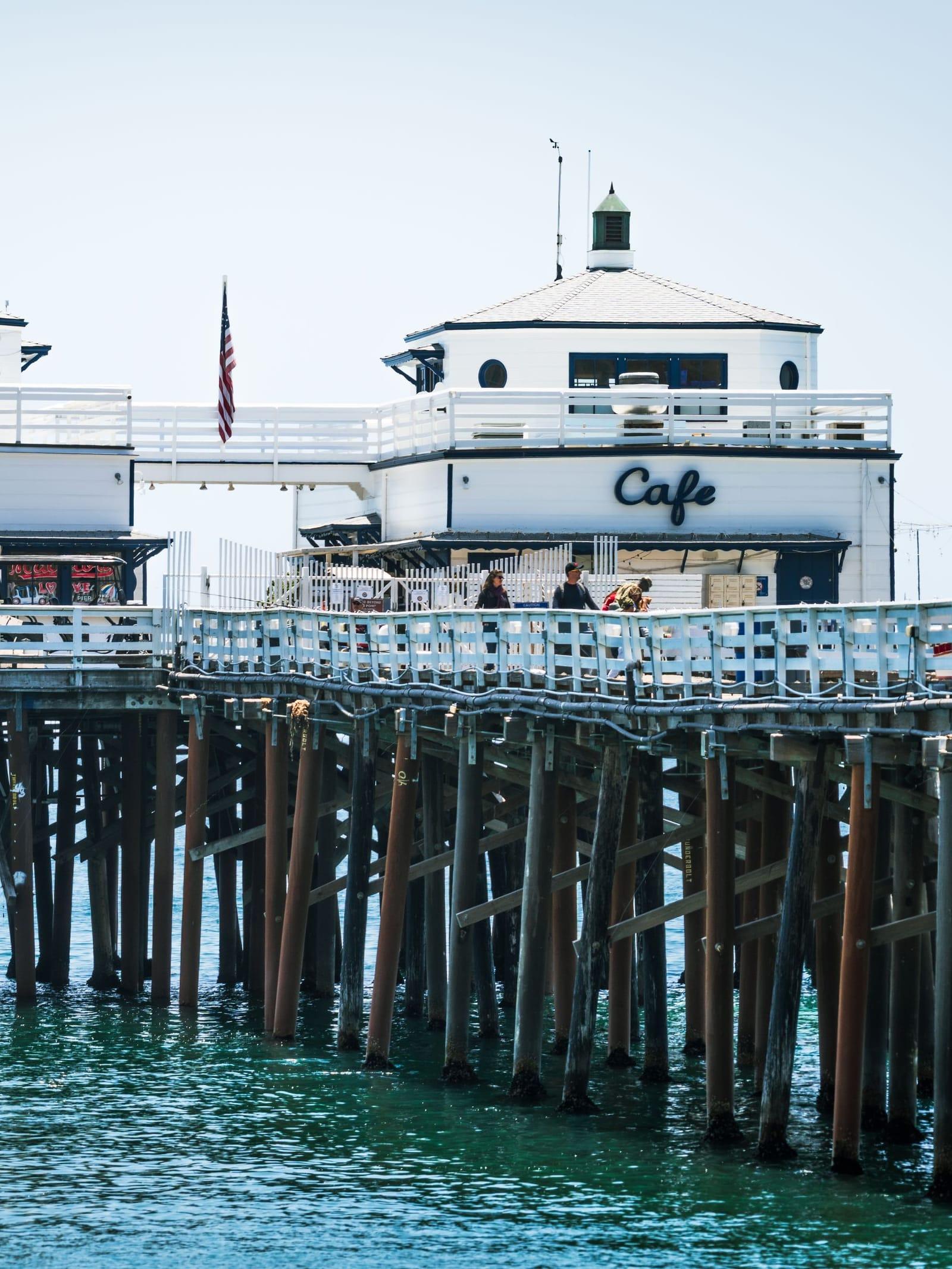 Malibu Pier over clear blue water on a bright day