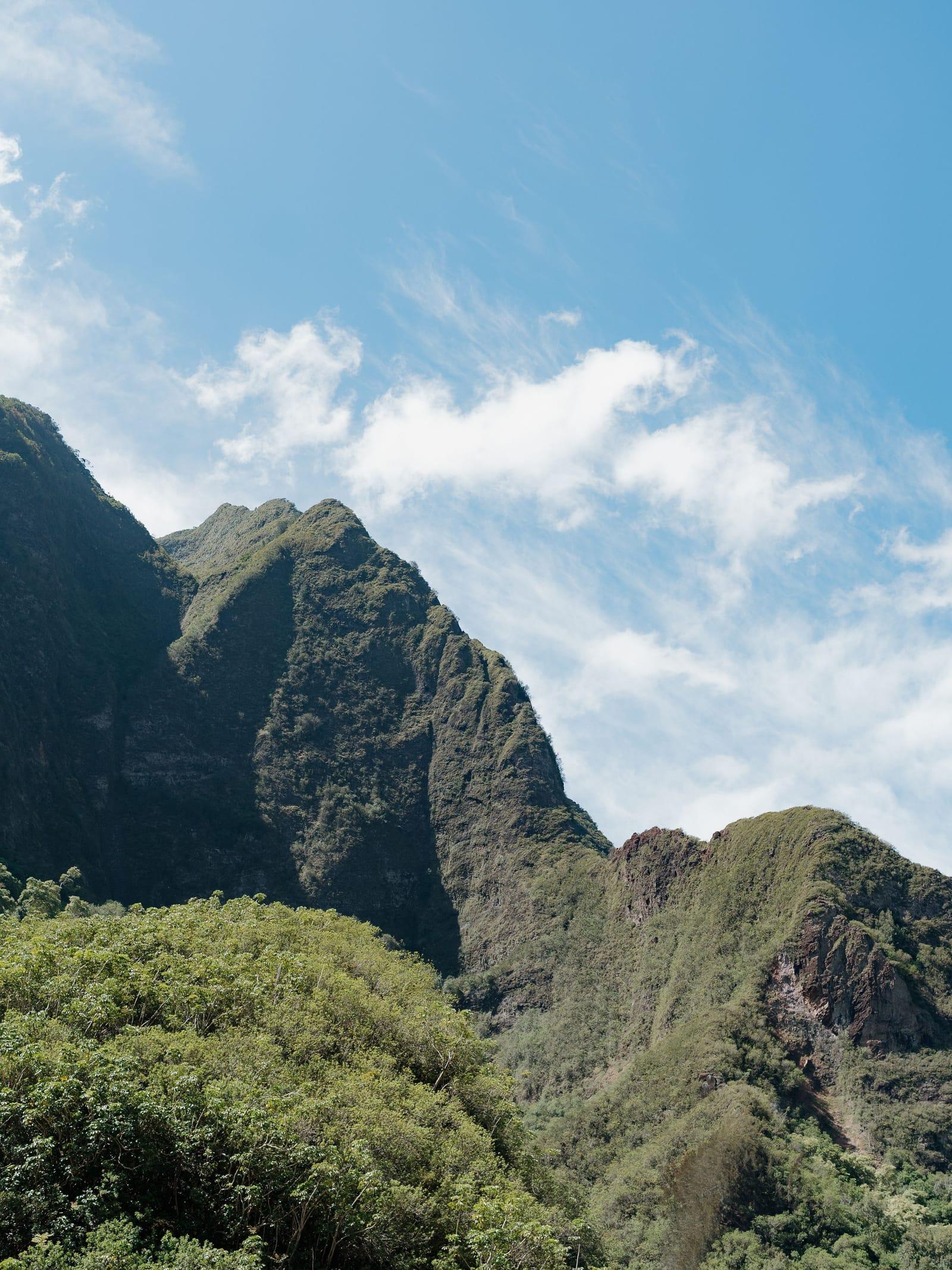 Green peaks of Iao Valley in the West Maui Mountains under a clear sky