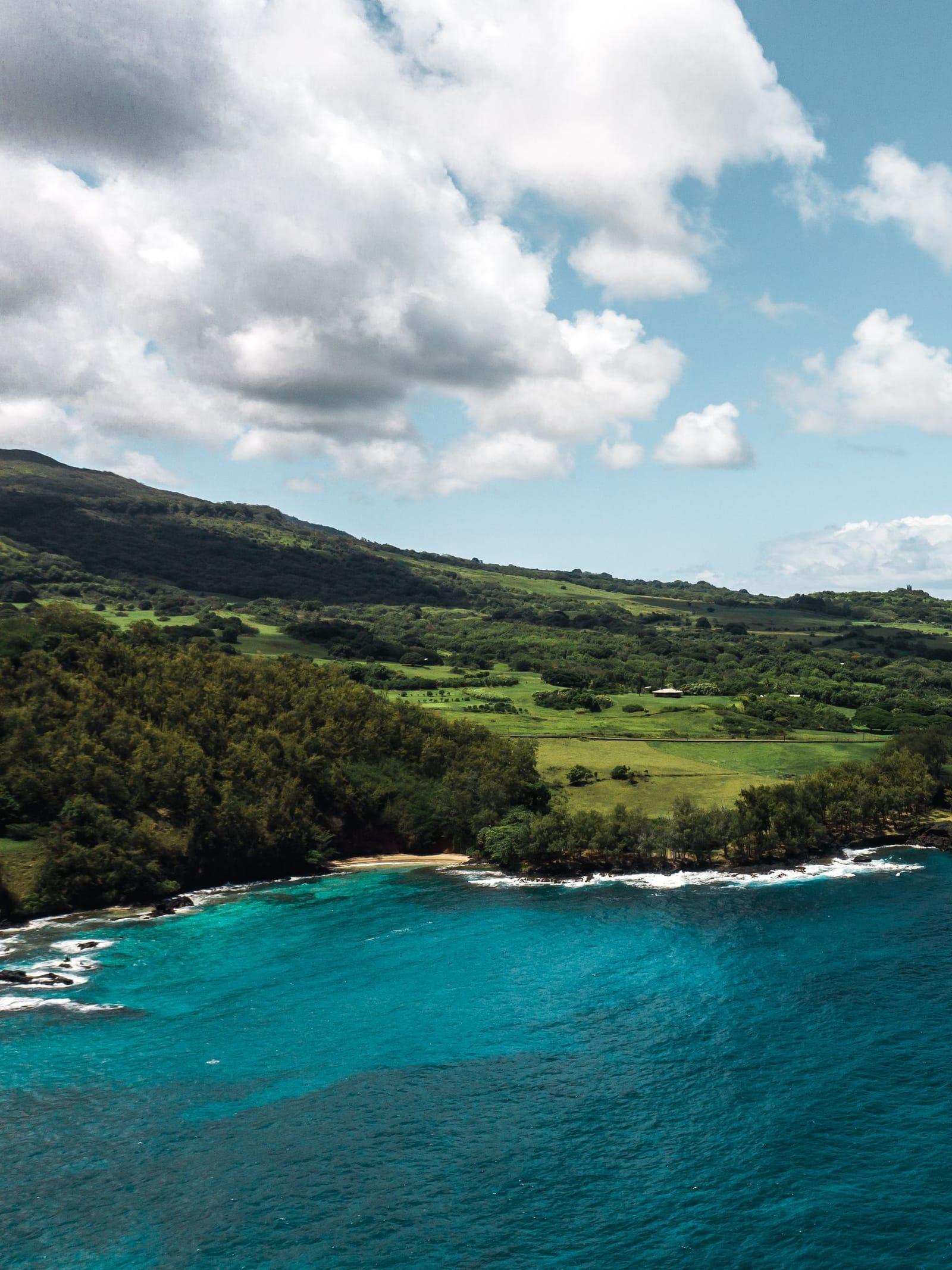 The green coastline near Hana and turquoise water from above