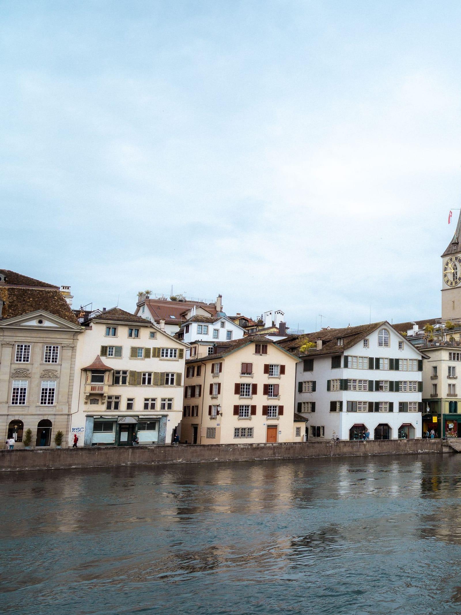 Zurich's old town houses and clock tower along the Limmat