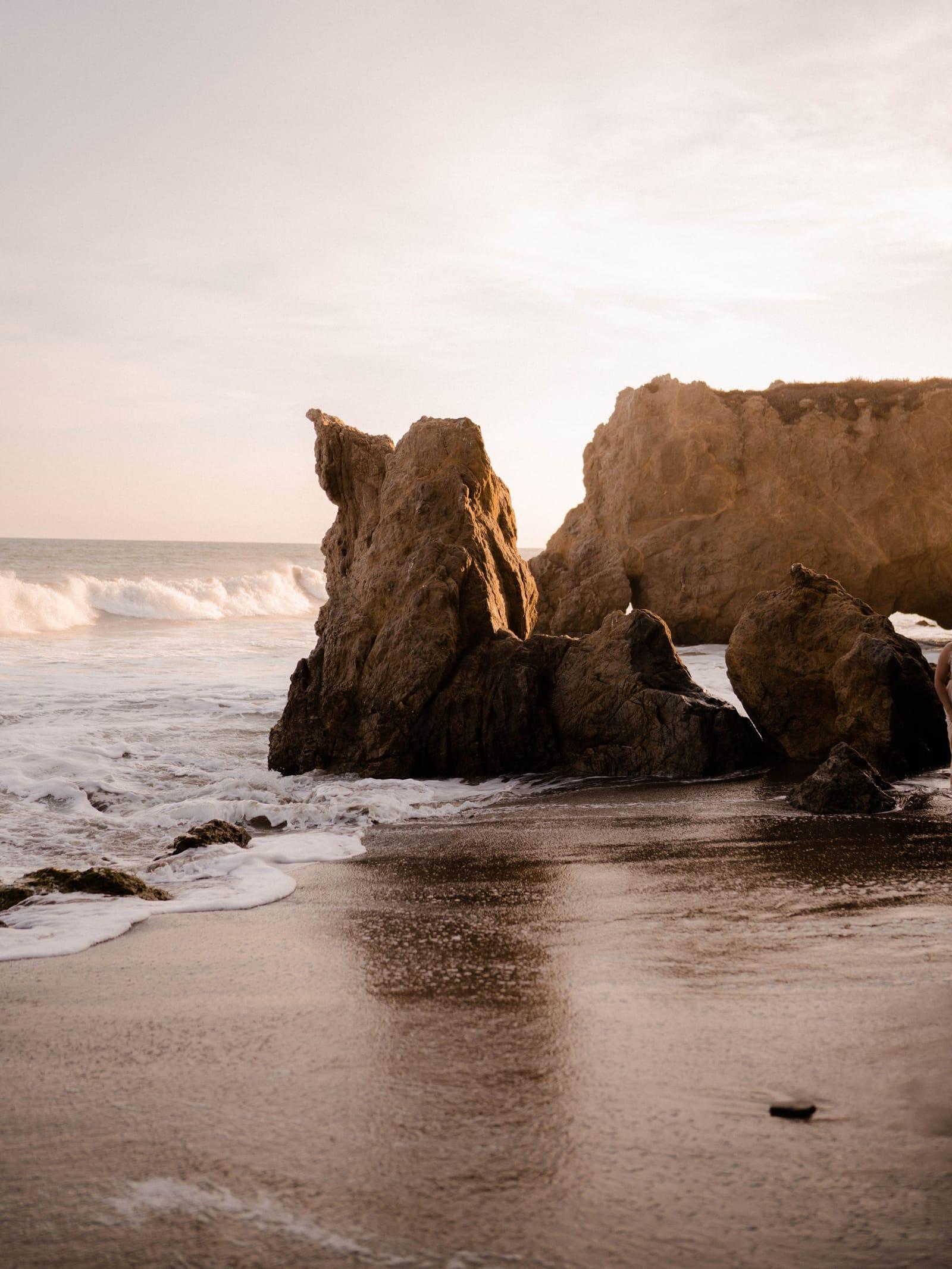Sandstone sea stacks on a Malibu beach in low golden light