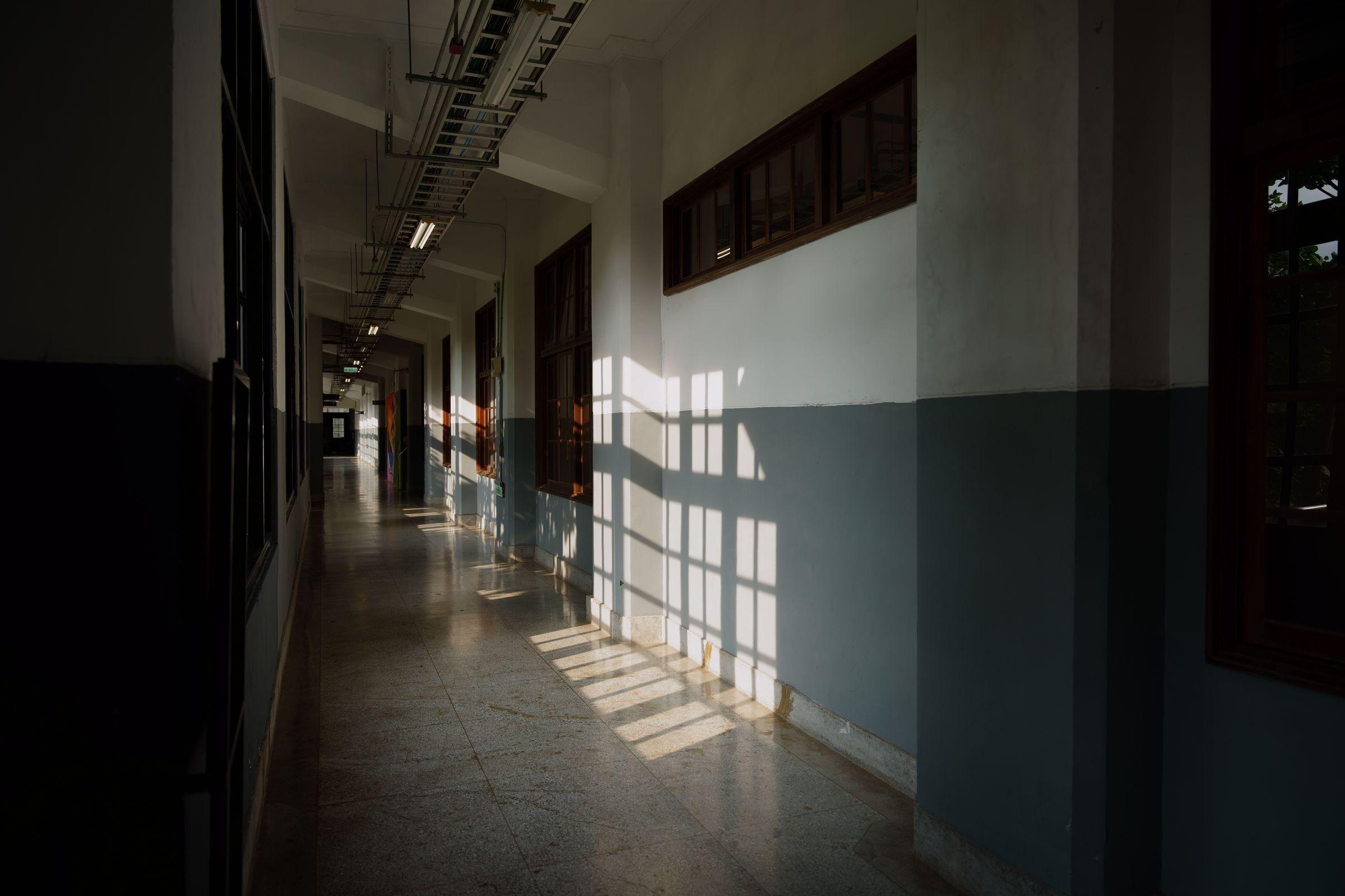 Sunlight through a quiet corridor — architectural restraint over the marketing-driven luxury aesthetic