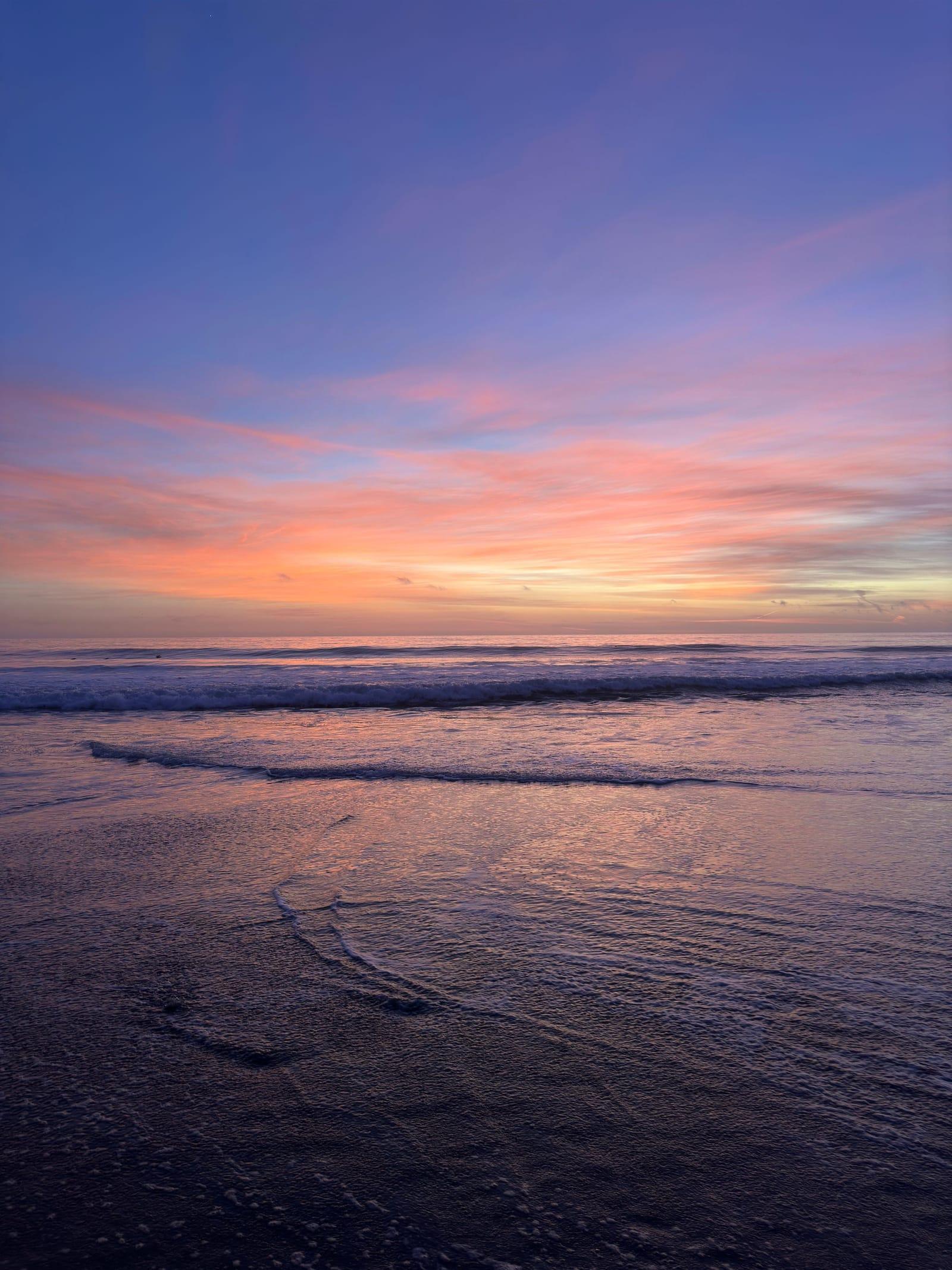 A violet and orange sunset over a Malibu beach
