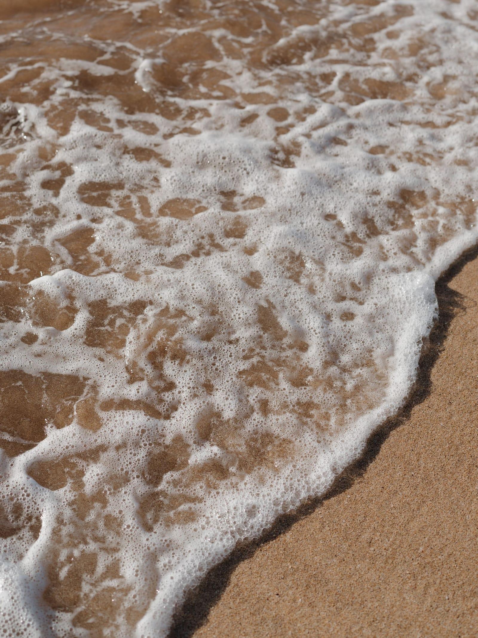 Gentle waves running up a sandy shore at Wailea, Maui