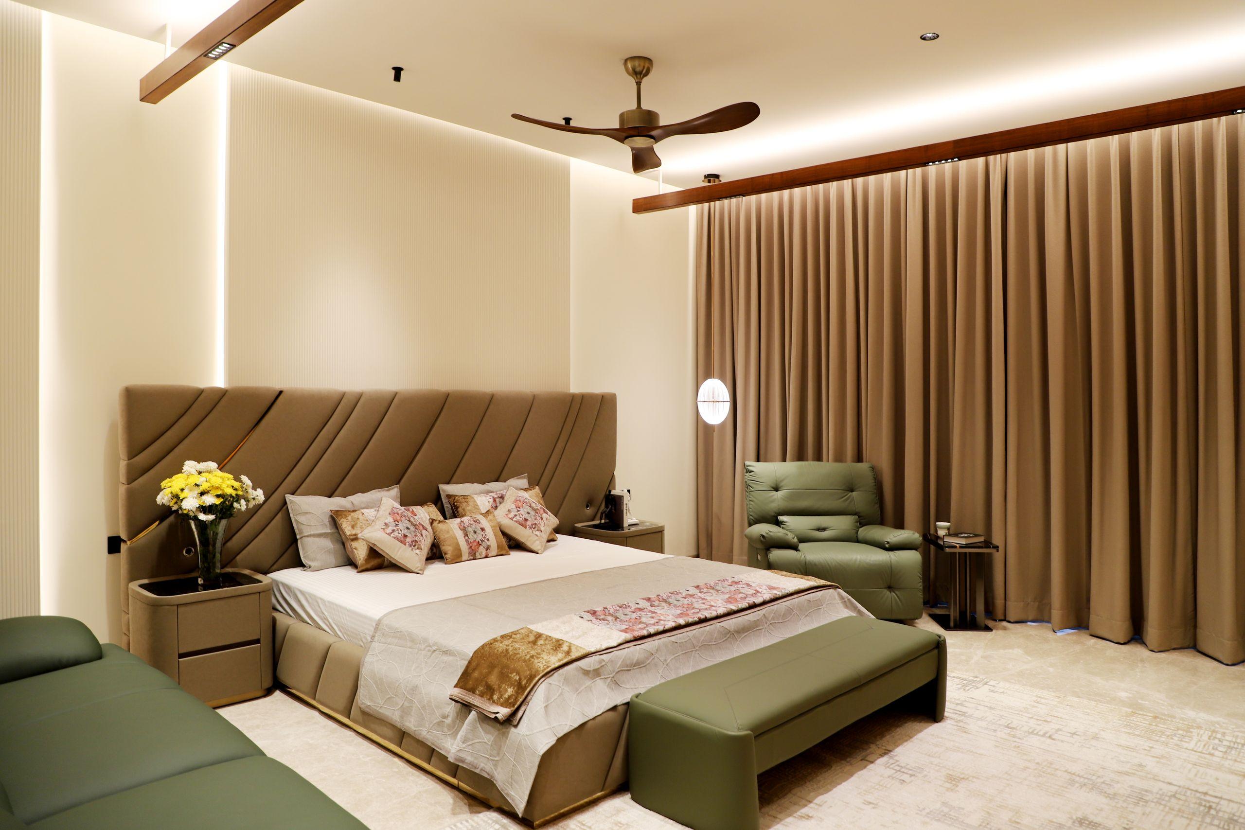 An upscale bedroom suite in warm, soft light, with plush bedding and elegant contemporary furnishings