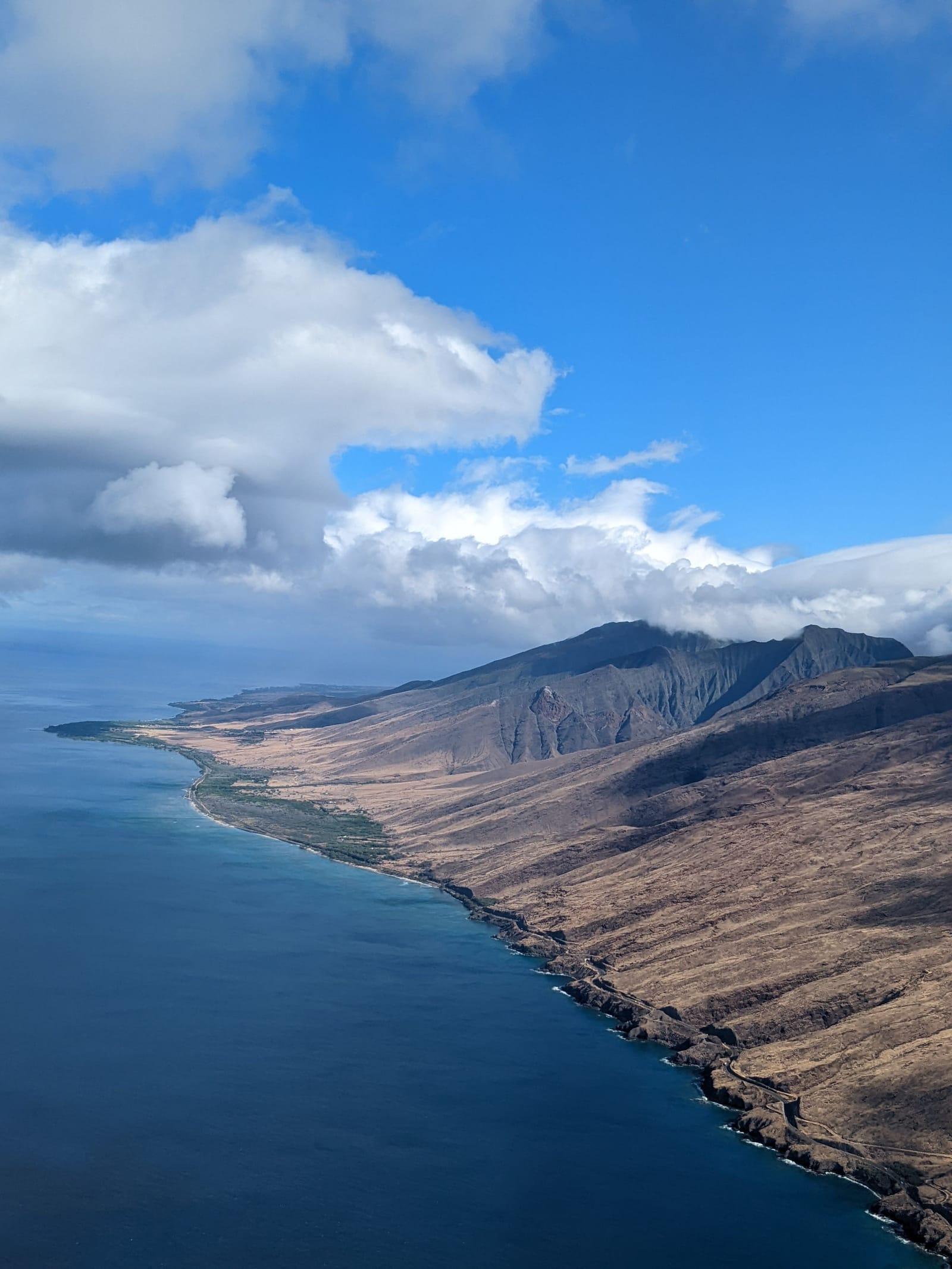 A dry mountain ridge running down to deep blue ocean on the Maui coast
