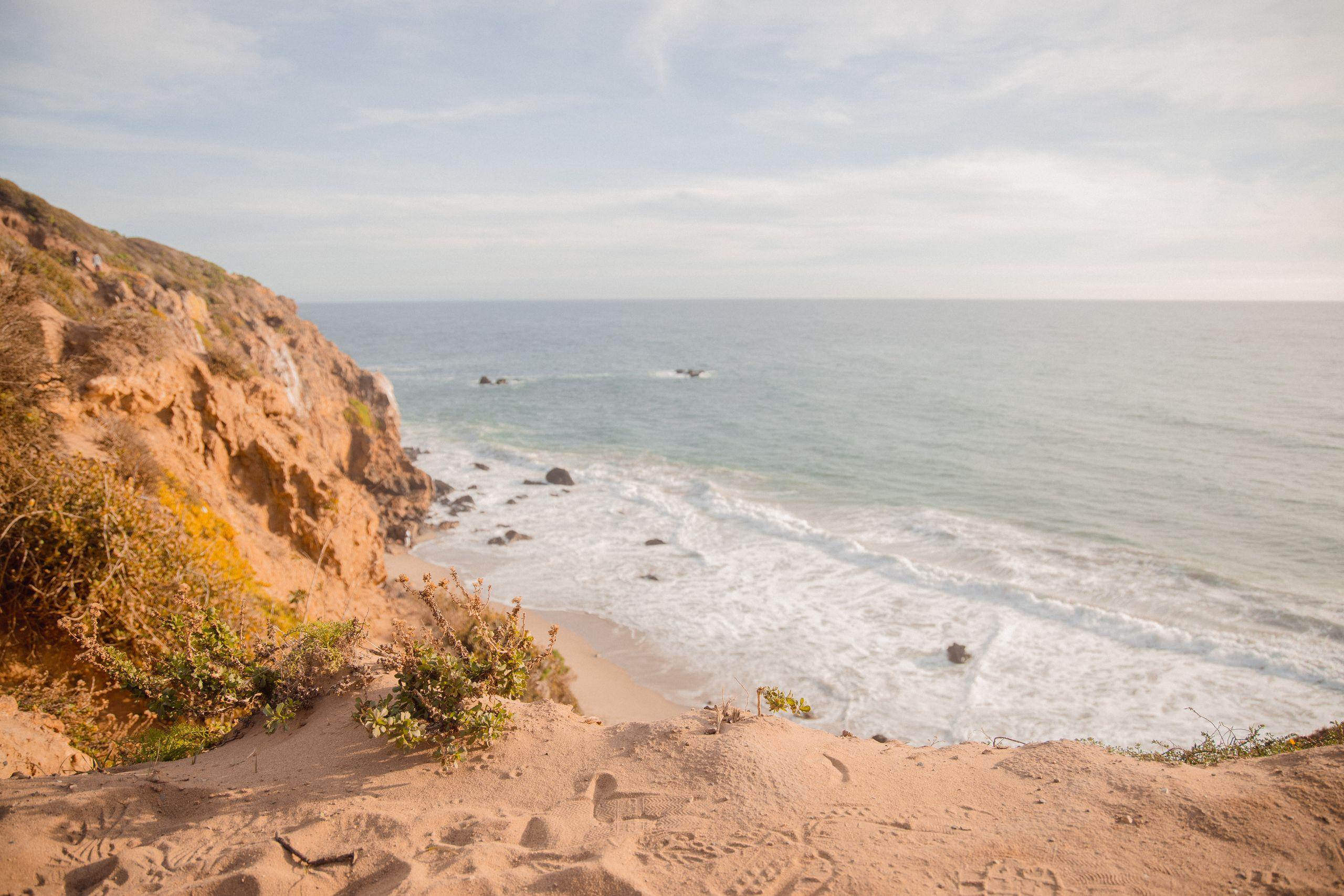 Rocky Malibu cliffs and the Pacific Ocean horizon on a sunny day