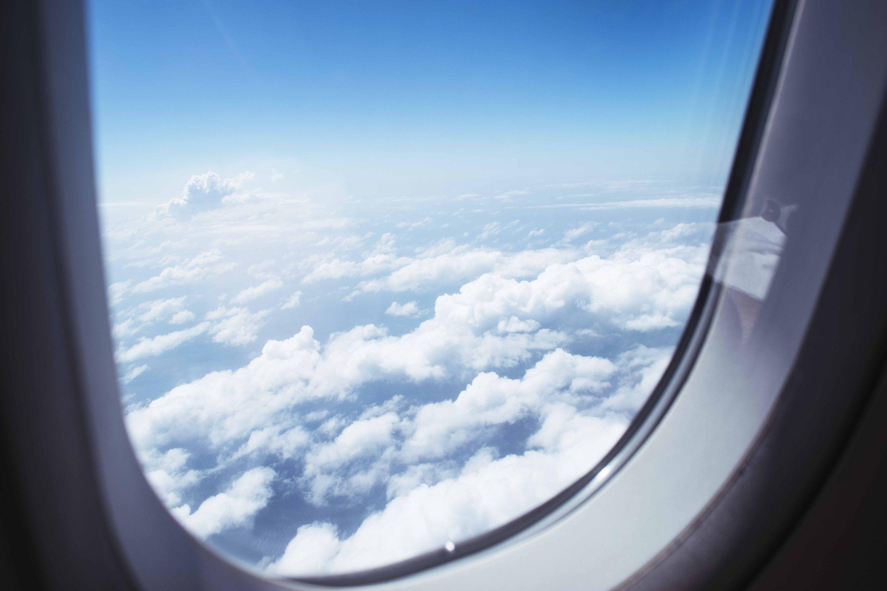 The view from an aeroplane window onto a bright field of white cloud